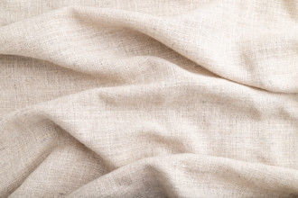 Fragment of white linen tissue. Side view, natural textile background and texture. wave concept,