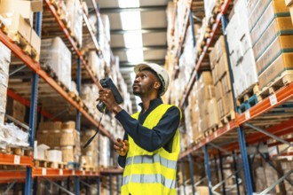 African man using scanner to read the barcodes and check the packages in a warehouse