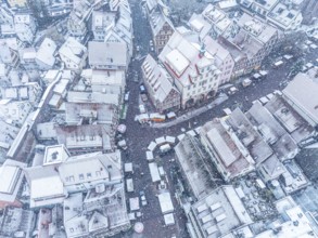 Winter aerial view of snow-covered streets and roofs of a small town, Black Forest, Calw, Germany,