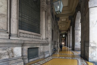 Arcaded walkway with mosaic floor from Palazzo della Borsa, built between 1907 and 1912, in Piazza