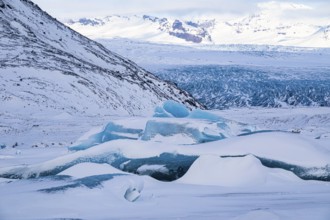 Snow-covered icebergs in the glacier lagoon Fjallsarlon, Breidamerkurjökull in the background,