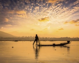 Myanmar travel attraction landmark, traditional Burmese fisherman sihouettes at Inle lake on