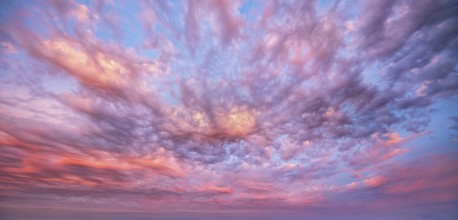 Atmospheric sky with luminous clouds at sunrise