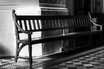 Black and white, wooden bench in the St. Mary's Church at Alexanderplatz, Berlin, Germany, Europe