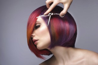 Portrait of beautiful woman with multi-colored hair and creative make up and hairstyle