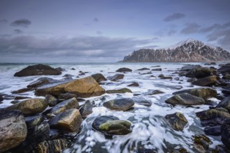 Rocky coast of fjord of Norwegian sea in winter. Skagsanden beach, Lofoten islands, Norway, Europe