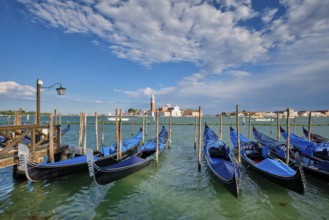 Gondolas and in lagoon of Venice by Saint Mark (San Marco) square with San Giorgio di Maggiore