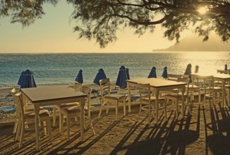 Gastronomy, tables and chairs on the beach, Plakias, Crete, Greece, Europe
