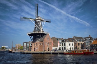 View of Harlem landmark windmill De Adriaan on Spaarne river. Harlem, Netherlands