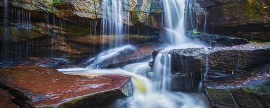 Panorama of tropical waterfall in jungle panorama with motion blur
