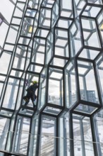 Window cleaners cleaning the glass facade of the Harpa Concert Hall and Congress Centre, interior