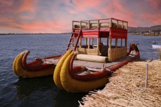Boat used by people living on the island of Los Uros in Lake Titicaca, beautiful sunset, Peru,