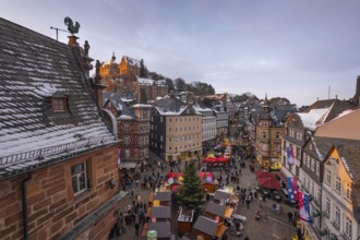The lights at the Christmas market in Marburg's old town centre begin to glow in the evening,