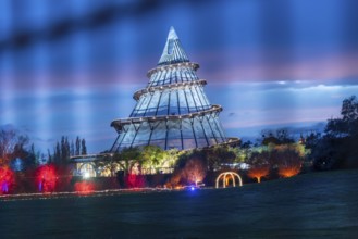 Red band of clouds passes the illuminated millennium tower in the Elbauenpark, landmark, Magdeburg,