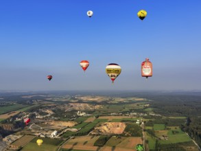 Many different hot-air balloons travelling in the blue sky, advertising, logo, hot-air balloon