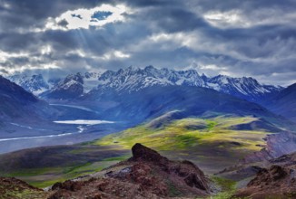 Himalayan landscape near Chandra Tal lake with sun rays coming through clouds. Himachal Pradesh,