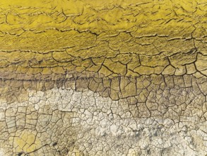 Mineral-rich cracked earth at the bank of the Rio Tinto (Red river), aerial view, drone shot,