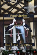 Sign at the restaurant Aux Trois Cigognes, Eguisheim, Département Haut-Rhin, Region Grand Est,