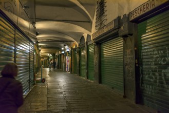 Closed shops in the old arcades at the harbour at night, Genoa, Italy, Europe