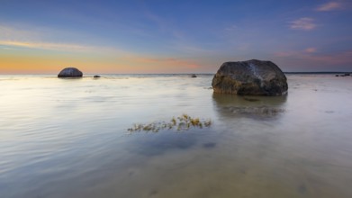 Large boulders on the beach of the Baltic Sea at sunset, Wismar Bay, Baltic Sea,