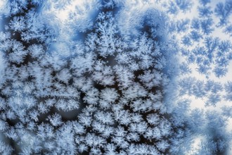 Ice crystals, snow crystals on glass, window pane of a flat in winter, illustration, symbol image,