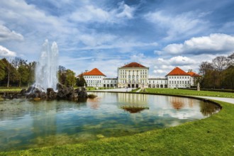 Fountain in Grand Parterre (Baroque garden) and the rear view of the Nymphenburg Palace. Munich,