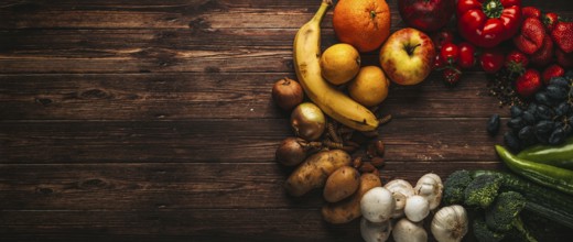 Fruit and vegetables on wooden table, background, symbolic image of healthy food