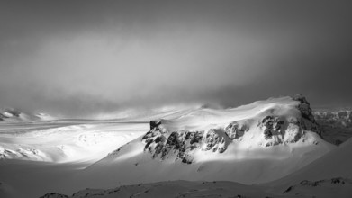 Fog, light and shadow on the snowy summit of Breidamerkurfjall, black and white photo, Sudurland,