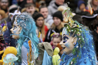 Person masked as Meerjugfrau at the carnival parade of the Wey guild on Rose Monday, Güdismäntig,