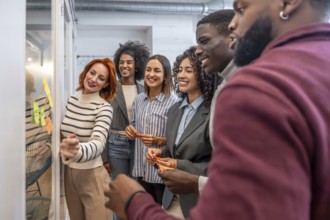 Side view of diverse males and females coworkers during a brainstorming creative process in the