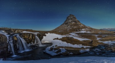 Long exposure panorama of the picturesque Kirkjufell mountain at night in winter in Iceland
