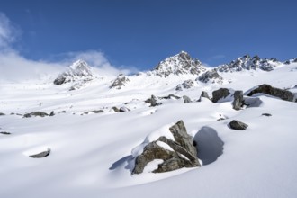 Picturesque snow-covered mountain landscape with peaks, ascent to the summit of Kesch Pitschen,