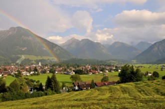 View over Oberstdorf with rainbow and Allgäu Alps, Oberallgäu, Bavaria, Germany, Europe