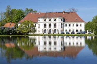 Baroque castle with reflection in the large pond, Königswartha, Upper Lusatia, Saxony, Germany,