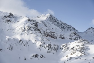 Mountain landscape with mountain peak Piz Surgonda in winter, view at the Chamanna Jenatsch in