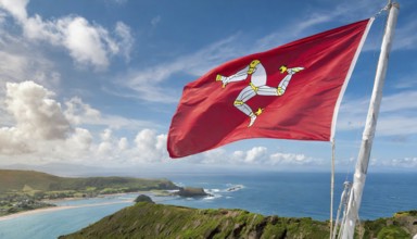 The flag of the Isle of Man, Great Britain, flutters in the wind