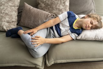 Growing pains in children, boy, 10 years old, has pain in his leg, symbolic picture