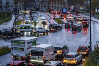 Rainy weather, road traffic, intersection, lights of vehicles on a wet road, traffic lights, tail