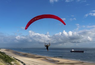 Paragliders along the dunes of Zoutelande, in Zeeland, South Holland, Netherlands