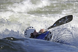 Kayaker kayaking in kayak in white water rapid