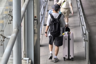 Tourist with trolley case