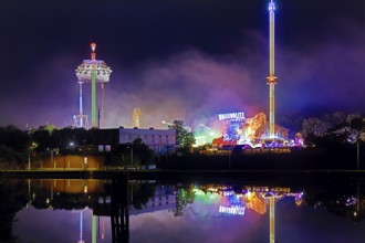 Rhine-Herne Canal with the Cranger Kirmes at night on the other side of the canal, Herne, Ruhr