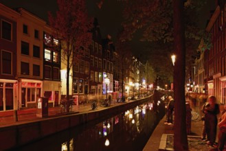 Night shot of the Oudezijds Achterburgwal in the red light district in Amsterdam, North Holland,