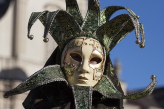 Venetian carnival mask and costumes at the Venetian fair on the historic market square,