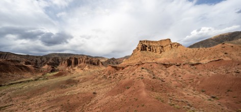 Eroded mountain landscape with sandstone cliffs, red and orange rock formations, Konorchek Canyon,