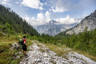 Mountaineer descending via the Ofental valley, mountain peak of the horse-rider Alpe behind,
