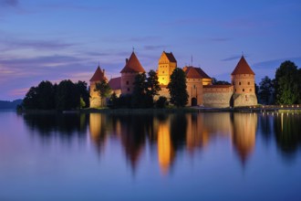 Night view of Trakai Island Castle in lake Galve illuminated in the evening, Lithuania, Europe