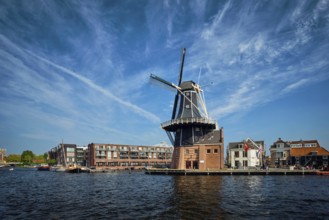 View of Harlem landmark windmill De Adriaan on Spaarne river. Harlem, Netherlands