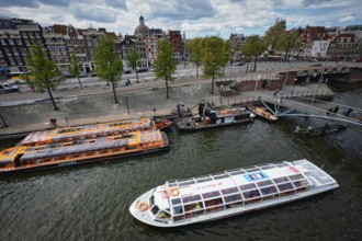 AMSTERDAM, NETHERLANDS, MAY 9, 2017: Aerial view of Amsterdam canal with tourist boats near