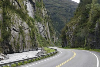 Road leads through a narrow canyon, high cliffs and Chugach Mountains, Thompson Pass, Richardson